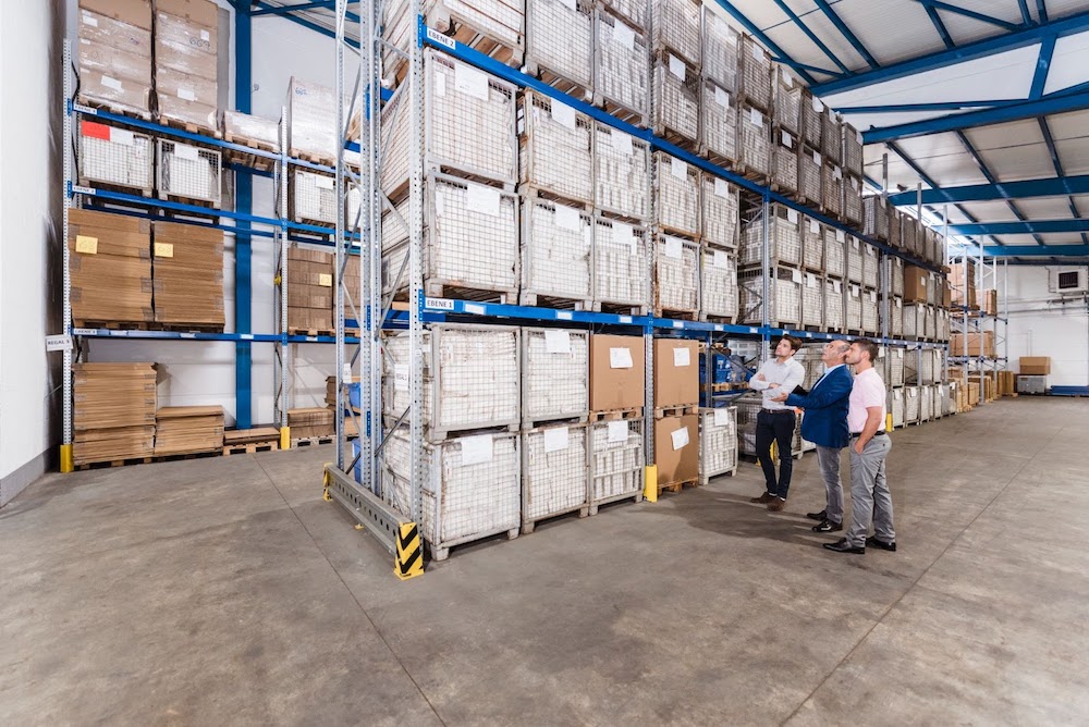 Business people waiting in a commercial storage warehouse.
